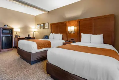 a hotel room with two beds and a television at Comfort Suites Bethlehem Near Lehigh University and LVI Airport in Bethlehem