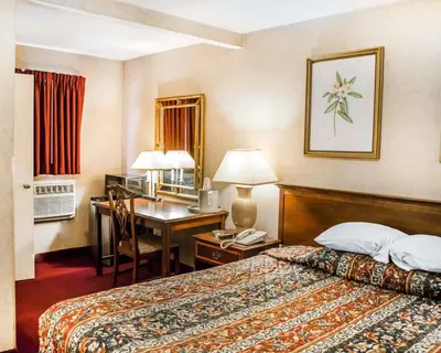 a hotel room with a bed and a desk at Rodeway Inn Dillsburg in Dillsburg