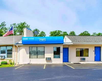 a building with an american flag in a parking lot at Rodeway Inn Dillsburg in Dillsburg