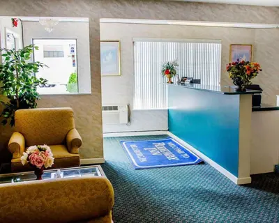 a waiting room with a chair and a blue rug at Rodeway Inn Dillsburg in Dillsburg