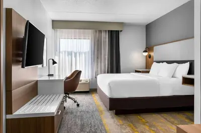 a hotel room with a large bed and a television at Comfort Inn & Suites York North in York