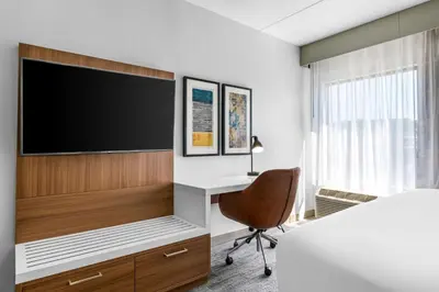 a bedroom with a tv and a desk and a chair at Comfort Inn & Suites York North in York