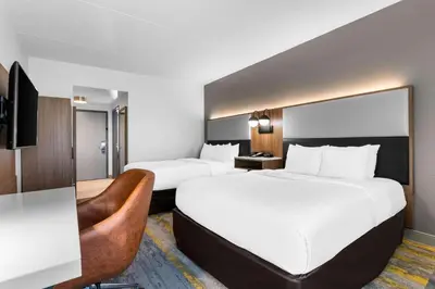 a hotel room with two beds and a television at Comfort Inn & Suites York North in York