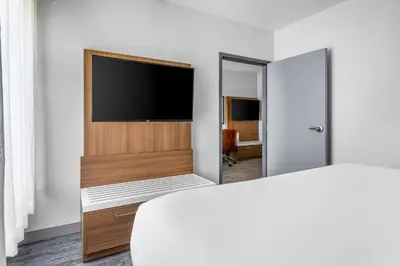 a hotel room with a bed and a flat screen tv at Comfort Inn & Suites York North in York