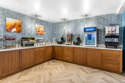 a coffee shop with wooden cabinets and a cash register at Comfort Inn & Suites York North in York