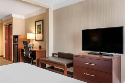 a hotel room with a bed and a flat screen tv at Comfort Suites Downtown Carlisle in Carlisle