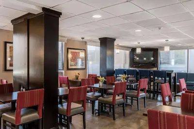 a dining room with tables and chairs and a tv at Comfort Inn - Pocono Mountains in White Haven