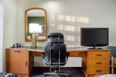 an office with a desk with a chair and a television at Sleep Inn & Suites Bensalem in Bensalem