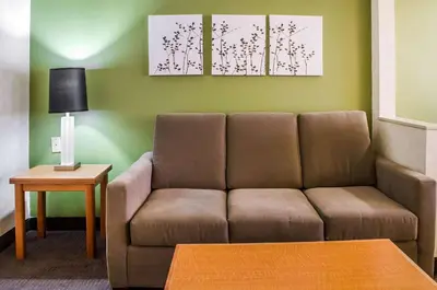 a living room with a couch and a table at Sleep Inn & Suites Bensalem in Bensalem