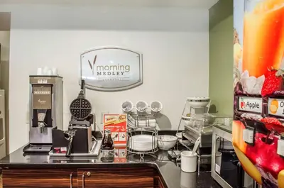 a kitchen with a counter with a morning kitchen sign at Sleep Inn & Suites Bensalem in Bensalem