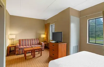 a hotel room with a couch and a television at Extended Stay America Suites - Lancaster County in Mountville