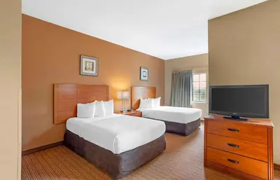 a hotel room with two beds and a flat screen tv at Extended Stay America Suites - Lancaster County in Mountville
