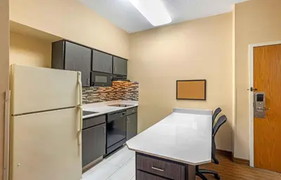 a kitchen with a white refrigerator and a table at Extended Stay America Suites - Lancaster County in Mountville