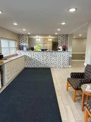 a lobby with a counter and chairs and a bar at Days Inn by Wyndham Moosic in Moosic