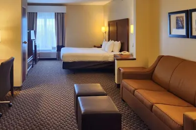 a hotel room with a bed and a couch at Comfort Inn & Suites Mount Pocono in Mount Pocono