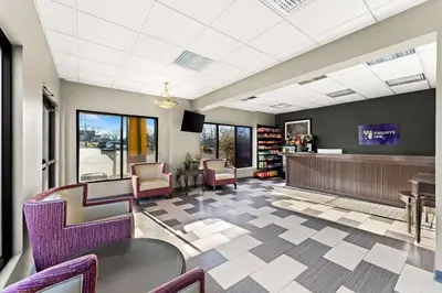 a lobby with purple chairs and a waiting room at Knights Inn Montgomeryville in Montgomeryville