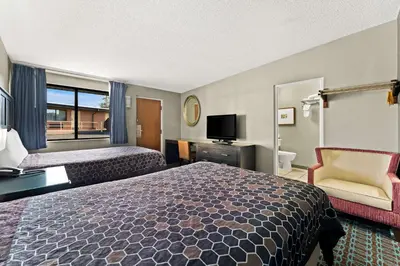 a hotel room with two beds and a television at Knights Inn Montgomeryville in Montgomeryville