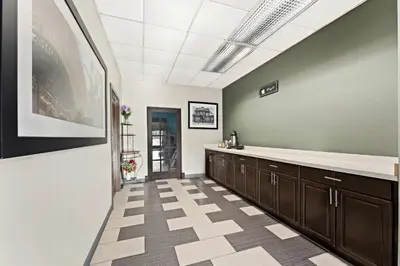 a kitchen with brown cabinets and a tile floor at Knights Inn Montgomeryville in Montgomeryville