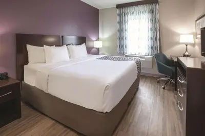 a hotel room with a large bed and a window at La Quinta by Wyndham New Cumberland - Harrisburg in New Cumberland