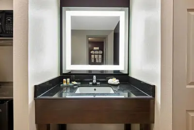 a bathroom with a sink and a mirror at La Quinta by Wyndham New Cumberland - Harrisburg in New Cumberland