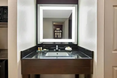 a bathroom with a sink and a mirror at La Quinta by Wyndham New Cumberland - Harrisburg in New Cumberland