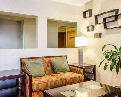 a living room with a couch and a table at Quality Inn Harrisburg - Hershey Area in Harrisburg