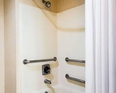 a shower in a hotel room with a curtain at Quality Inn Harrisburg - Hershey Area in Harrisburg