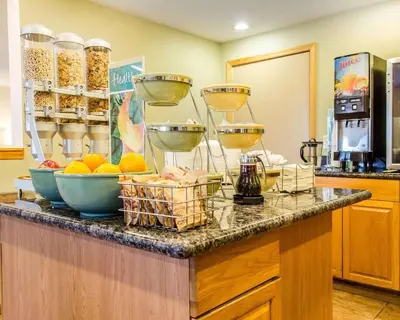 a counter with bowls of food on top of it at Quality Inn Harrisburg - Hershey Area in Harrisburg