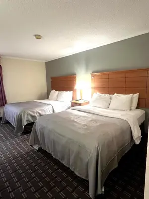a hotel room with two beds and a lamp at Quality Inn Harrisburg - Hershey Area in Harrisburg