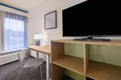 a hotel room with a large flat screen tv at Spark by Hilton Clarks Summit in Clarks Summit