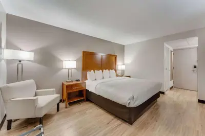 a hotel room with a bed and a chair at Quality Inn Easton in Easton