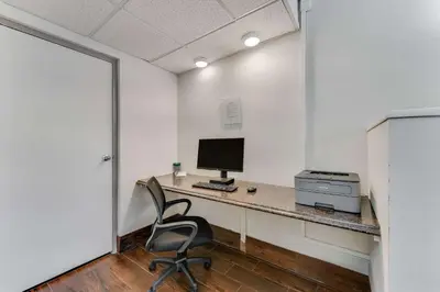 a room with a desk with a computer and a chair at Quality Inn Easton in Easton