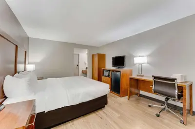 a hotel room with a bed and a desk and a television at Quality Inn Easton in Easton