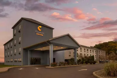 a building with a sign on the front of it at Comfort Suites Bloomsburg in Bloomsburg