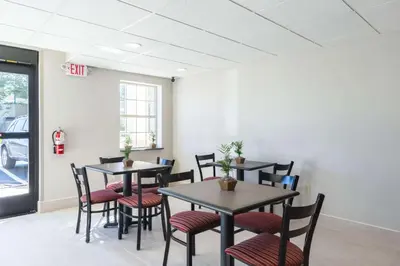 a dining room with tables and chairs and a fire hydrant at Econo Lodge Harrisburg - Southwest of Hershey Area in Harrisburg