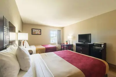a hotel room with two beds and a flat screen tv at Econo Lodge Harrisburg - Southwest of Hershey Area in Harrisburg