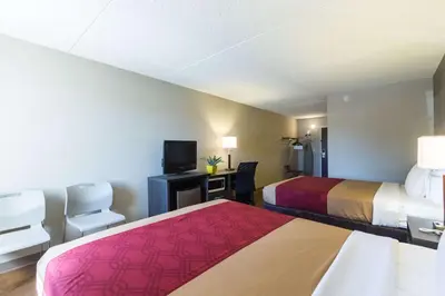 a hotel room with two beds and a television at Econo Lodge Harrisburg - Southwest of Hershey Area in Harrisburg
