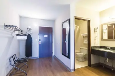 a bathroom with a sink and a toilet and a mirror at Econo Lodge Harrisburg - Southwest of Hershey Area in Harrisburg