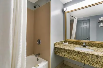 a bathroom with a sink and a mirror at HomeTowne Studios by Red Roof Denver, PA in Denver