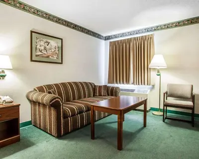 a living room with a couch and a table at Quality Inn Midway in Bethel