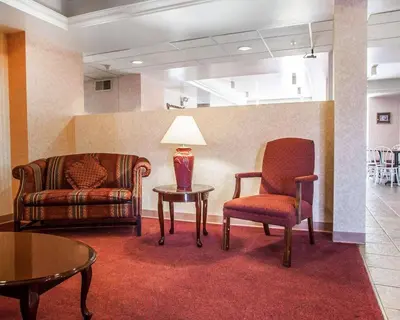 a waiting room with a chair and a table at Quality Inn Midway in Bethel
