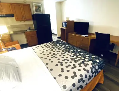 a bedroom with a bed with a black and white pattern at Travelodge by Wyndham Shamokin Dam/Selinsgrove in Shamokin Dam