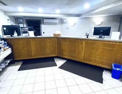 a bar in a restaurant with a counter at Travelodge by Wyndham Shamokin Dam/Selinsgrove in Shamokin Dam