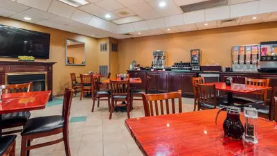 a restaurant with tables and chairs and a bar at Inn at Mendehall in Mendenhall