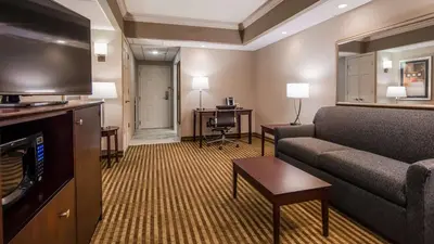 a living room with a couch and a television at Inn at Mendehall in Mendenhall
