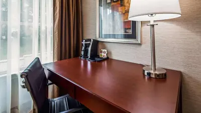 a desk in a hotel room with a lamp on it at Inn at Mendehall in Mendenhall