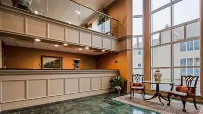 a lobby with a table and chairs in a building at Inn at Mendehall in Mendenhall