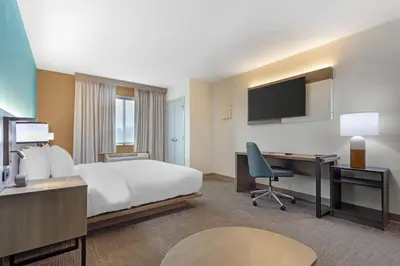 a hotel room with a bed and a desk and a computer at Comfort Suites Lewisburg near University in Lewisburg