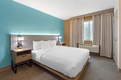 a hotel room with a large bed and a window at Comfort Suites Lewisburg near University in Lewisburg