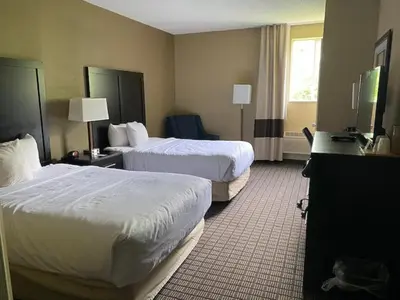 a hotel room with two beds and a television at SureStay Plus by Best Western Jonestown Lebanon Valley in Jonestown